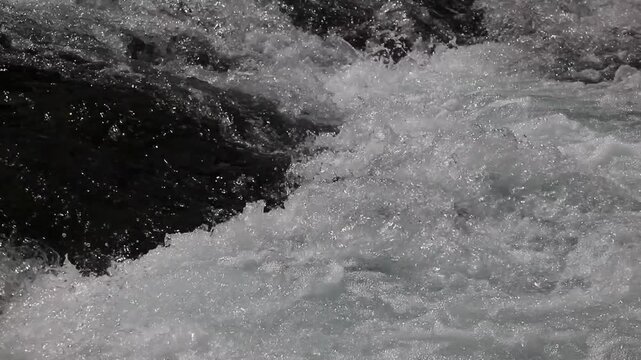 Detail of water flowing in a stream, fresh and natural landscape, video with audio in background