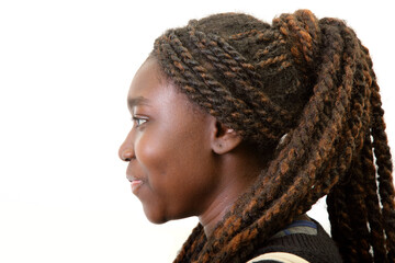 Side profile portrait of a young Black woman with long braided hair in a high ponytail isolated on white © Jacques Durocher