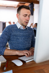 Fototapeta premium Focused man typing office work.