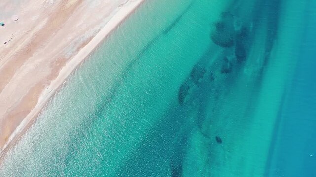 Abstract top-down drone shot rising over blue water gradient in Pangong Lake Ladakh, India.. High Altitude Lake in Greater Himalayas