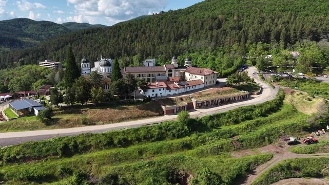 Aerial 4K view of Kremikovtsi Monastery St George and green mountain hills, Sofia region, Bulgaria