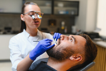 Fototapeta premium Dentist examining patient's teeth during a checkup