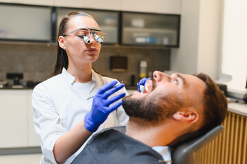 Fototapeta premium Dentist examining patient's oral health in clinic