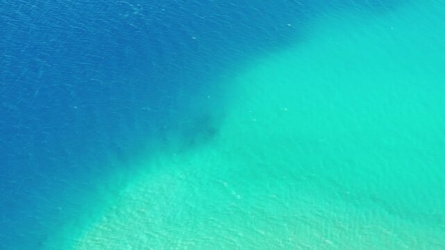 Bird's-eye view drone rising over pristine blue water at Pangong Lake.. High Altitude Lake in Greater Himalayas