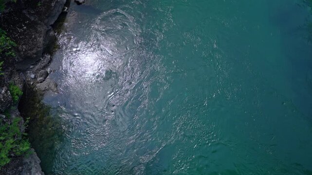Dark turquoise water surface with gentle ripple and shimmering reflection, calm sea or river texture, tranquil nature background, abstract water concept, summer serenity.