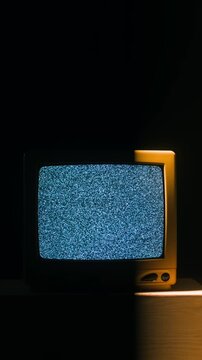 Retro TV, vintage television In a nostalgic setup, a retro TV displays grain on screen, scary halloween night device good for chroma key and green screen