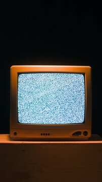 Retro TV, vintage television In a nostalgic setup, a retro TV displays grain on screen, scary halloween night device good for chroma key and green screen