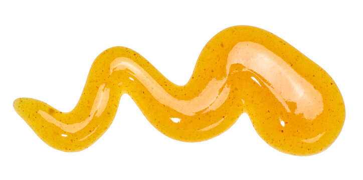 A wavy smear of yellow mustard sauce with small spice flecks on an isolated background.
