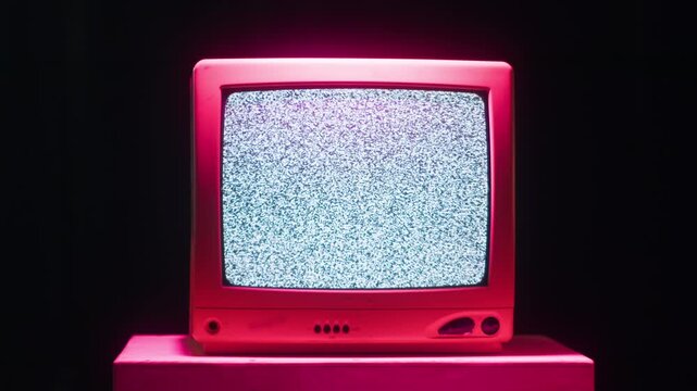 Retro TV, vintage television In a nostalgic setup, a retro TV displays grain on screen, scary halloween night device good for chroma key and green screen