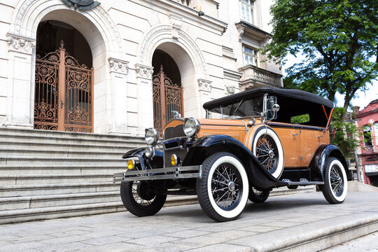 Classic Vintage Car from 1930, Cabriolet. Parked in Front of Historic Building in Black and White