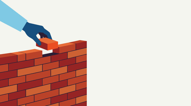 Building Success with hand placing the final brick on a red brick wall against a white background ideal for business growth concepts and teamwork presentations.