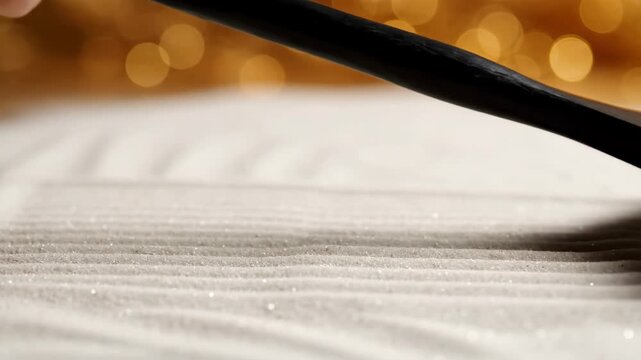 Rake tool creates parallel ridges on light sand surface. Process of smoothing dry sand in zen garden for meditation. Decorative texture design for spiritual focus