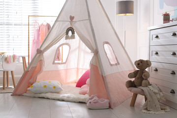 Cute wigwam, cushions and toy in stylish child's room © New Africa