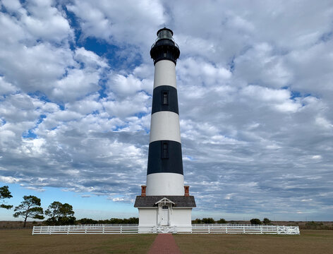 Bodie Island Lighthouse rises beneath a dramatic sky of textured clouds in the Outer Banks of North Carolina, a landmark of the Atlantic coast. Cape Hatteras National Seashore