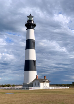 Bodie Island Lighthouse stands beneath dramatic storm clouds on North Carolina's Outer Banks, highlighting the region's maritime history and coastal scenery.