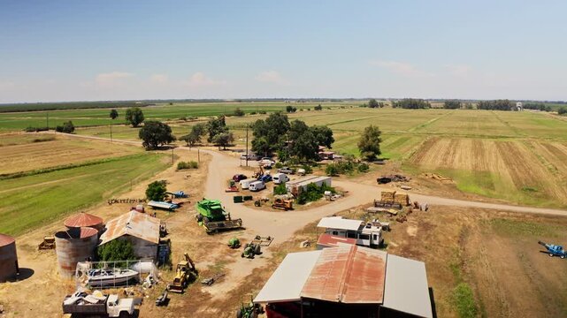 Drone aerial view of farmstead and acres of farmland in Chico, California 