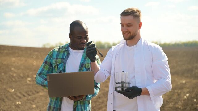 Scientist and farmer analyzing soil samples in an agricultural field