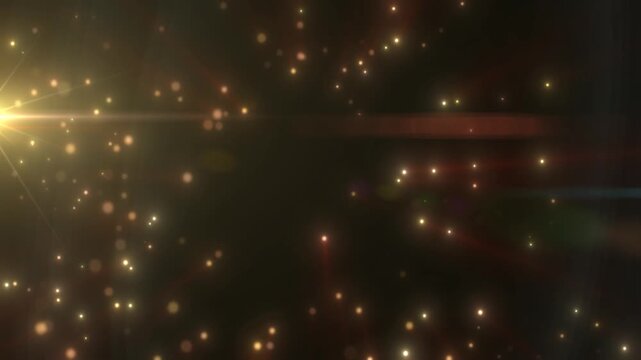 Warm golden particles scattered over a dark background with soft bokeh, horizontal lens flare, and cinematic glow