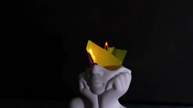 Creative ideas on mental health expressed through a burning in a head representing thoughts and emotions