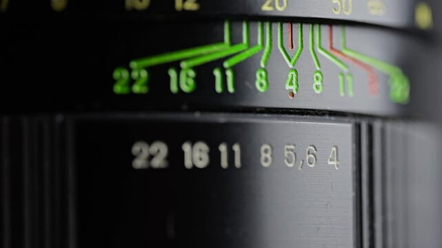 Extreme close-up of a vintage lens aperture ring shifting