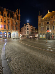 Fototapeta premium In the still of the night in Brugge city square with a full moon rising