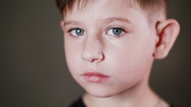 Emotional face of a boy, expression of different emotions