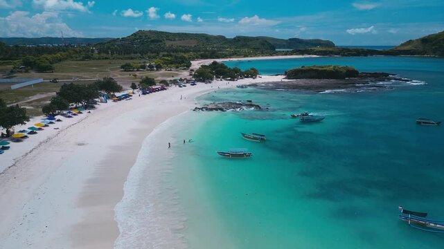 Small Boats Gather By White Sandy Beach. Fishing Boats And Charters Return Over Patterned Seabed. Aerial Perspective Of Vessels And Intricate Seafloor Designs Close To Pristine Beach, Lombok