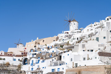Fototapeta premium White houses and windmill in Oia, Santorini, Greece
