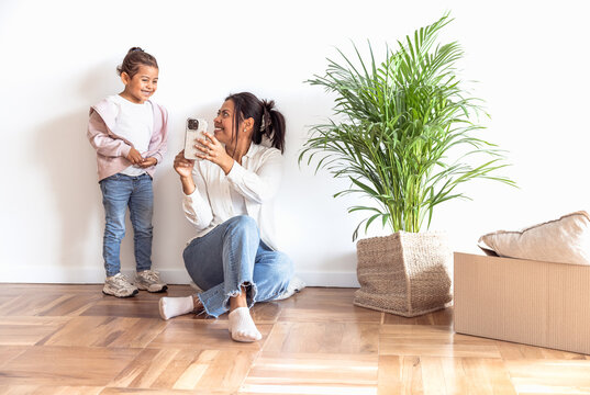 Mother with daughter during a facetime call in new home