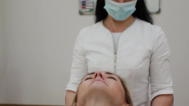 A female doctor, a professional cosmetologist, is preparing for a procedure