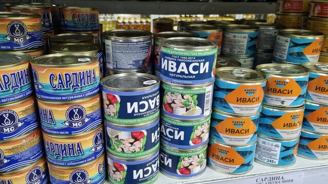 Canned Sardines and Japanese Sardine Iwashi on Supermarket Shelf