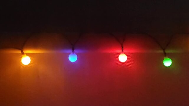 Cozy room lit by warm LED garland lights with soft glowing spherical bulbs.
