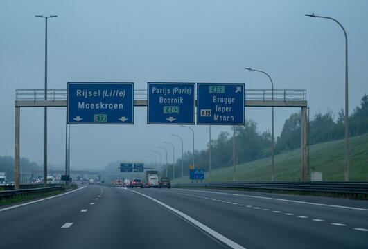 View of a French and European autoroute with overhead directional signs pointing to major cities like Paris, Bordeaux, Lille, Calais, showing lanes, traffic and motorway infrastructure, road signes