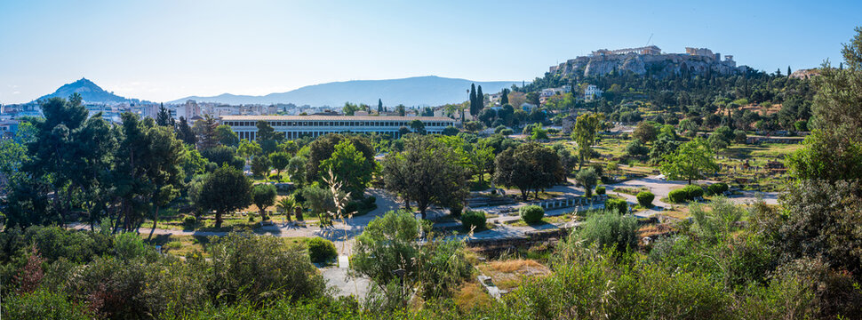 Panoramic view over the Ancient Agora archaeological site and the Acropolis hill in Athens, captured from the Temple of Hephaestus on a clear May morning.