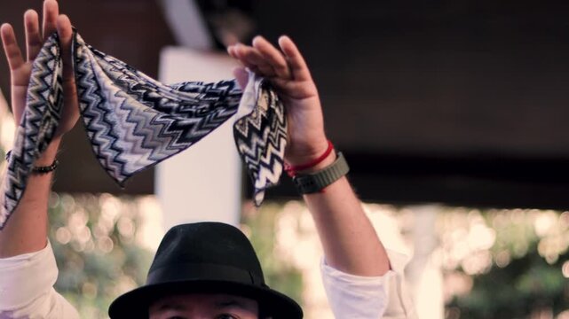 Adult man in formal attire dancing and waving his handkerchief in the air. Cueca brava, a traditional Chilean dance, symbolizing Chilean identity. National holidays.