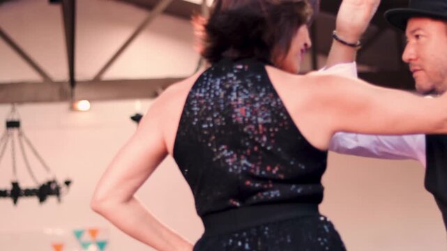 A couple of dancers in formal attire, dancing the cueca brava, looking at each other. With great style and glamour. Dance event. Typical Chilean dance, national dance of the national holidays.