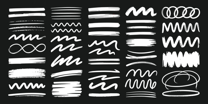 Hand drawn white chalk marker lines and squiggles set on dark chalkboard background isolated group