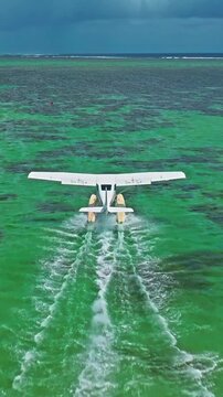 Aerial view of hydroplane is taking off or landing on a crystal clean water. Mauritius