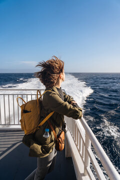 Pacified female standing on deck in wind