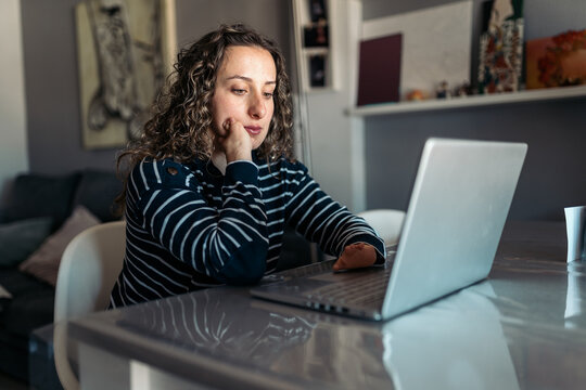 Woman with limb difference working on laptop