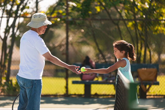Grandparent Teaches Grandchild Tennis