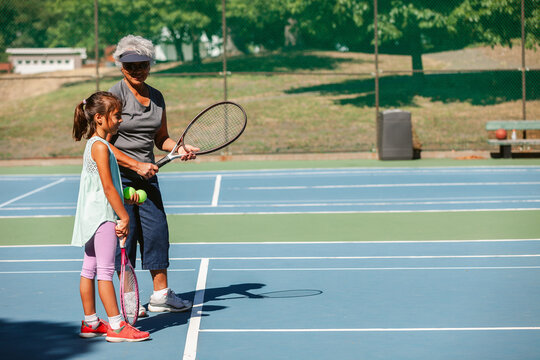 Grandma Teaches Grandchild Tennis Skills