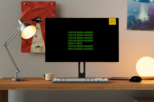 Clean desk setup with hacked message on screen