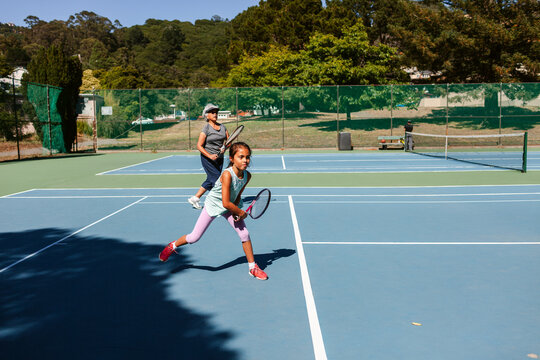 Grandma and grandchild playing tennis 