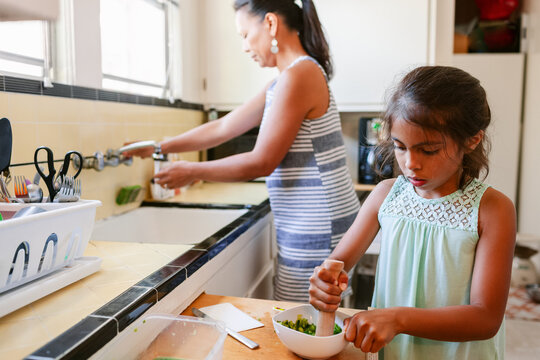 Girl Helping Mom Cook