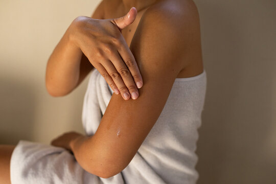 Skin care product in use in bathroom setting 