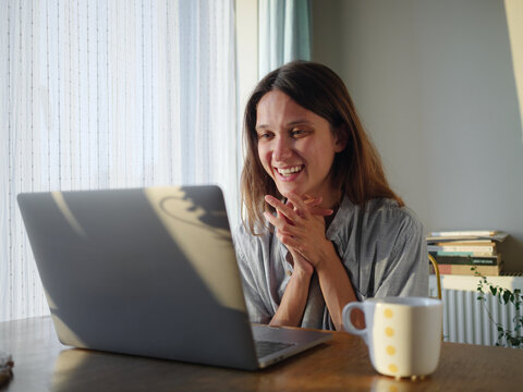Woman Enjoying Video Call at Home in Bright, Cozy Environment