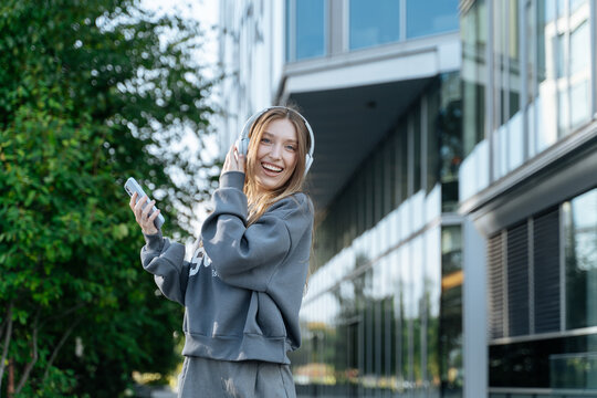 Young student girl with smartphone and headphones