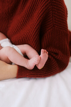 mom holding her newborn baby daughter