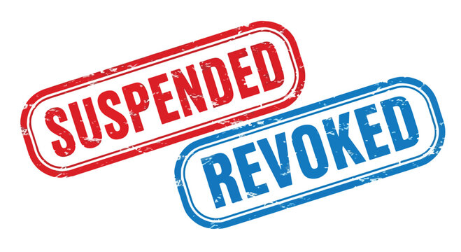 Close-up of two rubber stamps with red suspended and blue revoked ink indicating a canceled or invalid status